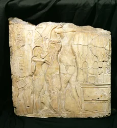 Relief Fragment Depicting Akhenaten Followed by Nefertiti and Meritaten Before an Offering Table